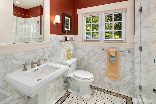 1712 Arch Ave SW, Seattle, WA 98116 - bathroom featuring a shower stall, tile walls, toilet, and a sink