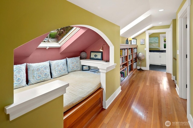 1712 Arch Ave SW, Seattle, WA 98116 - sitting room with baseboards, hardwood / wood-style floors, vaulted ceiling, arched walkways, and recessed lighting