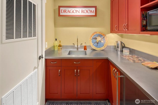 1712 Arch Ave SW, Seattle, WA 98116 - kitchen featuring stainless steel countertops, a heating unit, a sink, and black microwave