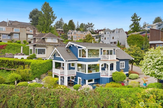 1712 Arch Ave SW, Seattle, WA 98116 - rear view of property featuring a balcony, a residential view, and a shingled roof