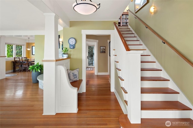 1712 Arch Ave SW, Seattle, WA 98116 - stairway with wood finished floors, baseboards, and crown molding