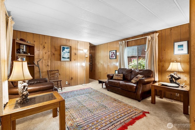 carpeted living room with wooden walls