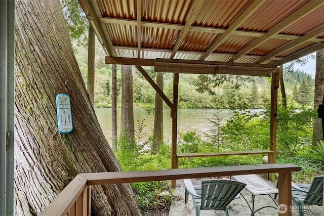 wooden terrace featuring a water view