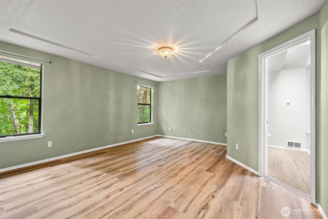 unfurnished room with wood finished floors and baseboards