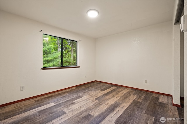 empty room with wood finished floors and baseboards