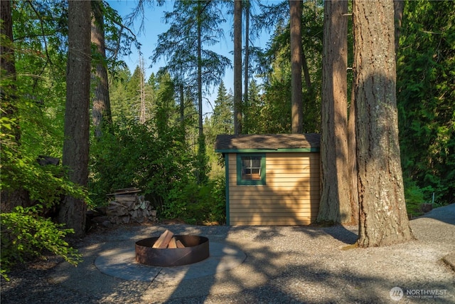 13901 Twin Lakes Dr E, Graham, WA 98338 - view of shed with an outdoor fire pit
