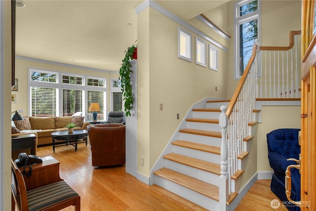 13901 Twin Lakes Dr E, Graham, WA 98338 - stairs featuring wood finished floors, baseboards, and ornamental molding