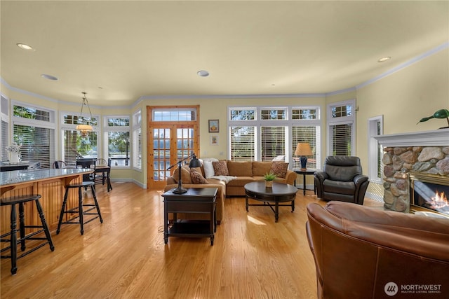 13901 Twin Lakes Dr E, Graham, WA 98338 - living area with ornamental molding, light wood-style floors, a stone fireplace, recessed lighting, and baseboards