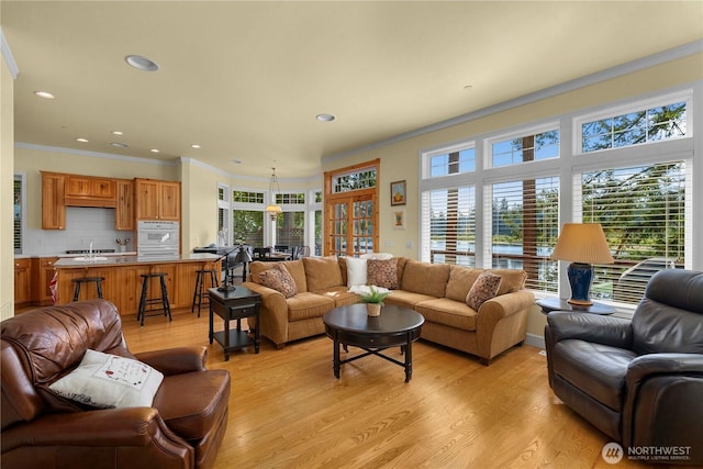 13901 Twin Lakes Dr E, Graham, WA 98338 - living area with crown molding, plenty of natural light, light wood-style floors, and recessed lighting