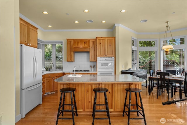 13901 Twin Lakes Dr E, Graham, WA 98338 - kitchen with white appliances, a sink, an island with sink, recessed lighting, and crown molding