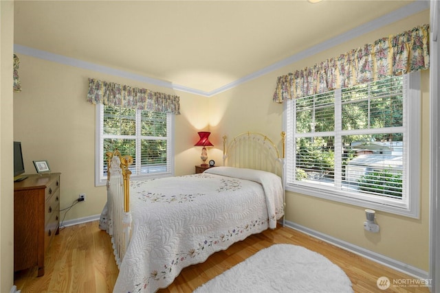 13901 Twin Lakes Dr E, Graham, WA 98338 - bedroom with multiple windows, crown molding, baseboards, and wood finished floors