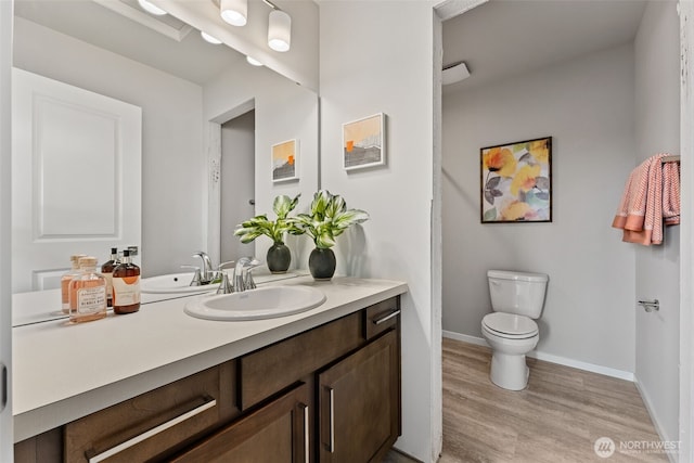 11 E Compass Ln, Allyn, WA 98524 - bathroom with wood finished floors, toilet, vanity, and baseboards