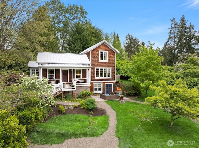 8285 NE Beck Rd, Bainbridge Island, WA 98110 - view of front facade with a front yard, a standing seam roof, metal roof, and a porch