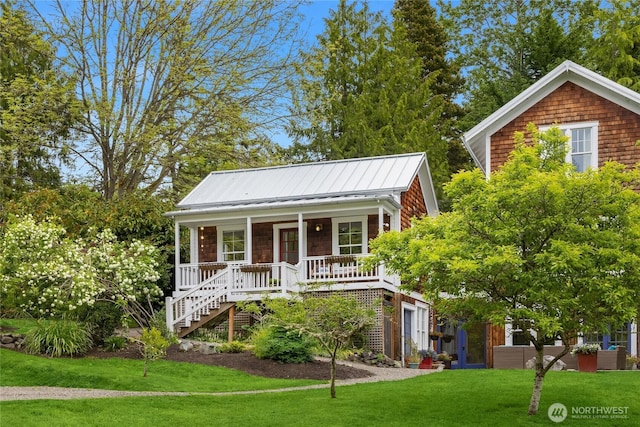8285 NE Beck Rd, Bainbridge Island, WA 98110 - view of front of property featuring stairs, a porch, a front yard, and metal roof