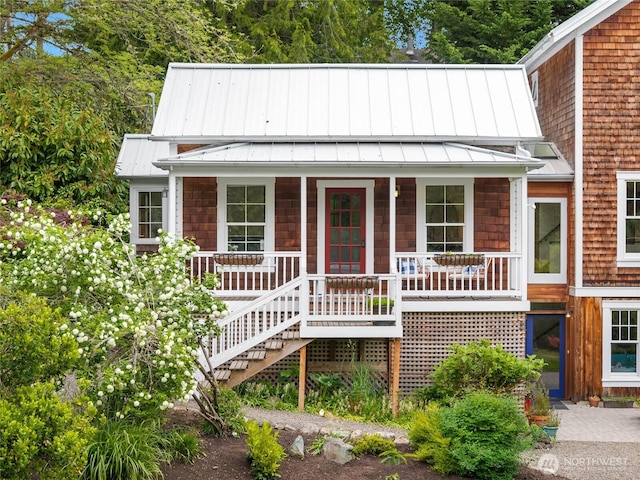 8285 NE Beck Rd, Bainbridge Island, WA 98110 - view of front of home with a standing seam roof, covered porch, and stairs