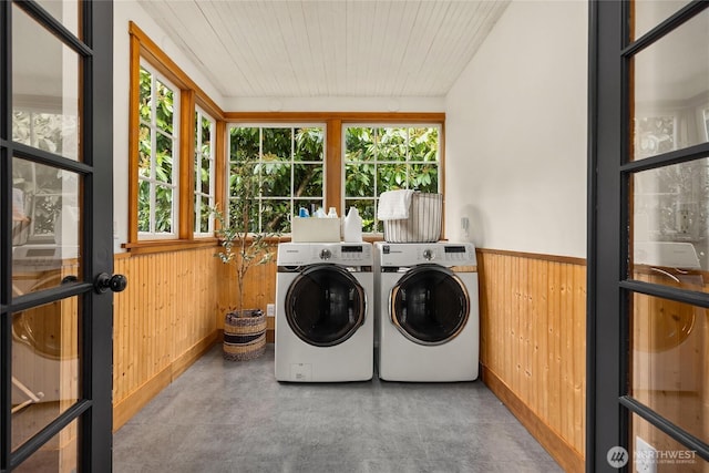 8285 NE Beck Rd, Bainbridge Island, WA 98110 - clothes washing area featuring washer and clothes dryer, wood walls, wainscoting, and wooden ceiling
