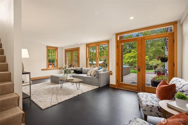 8285 NE Beck Rd, Bainbridge Island, WA 98110 - living room featuring concrete flooring, stairway, baseboards, french doors, and recessed lighting