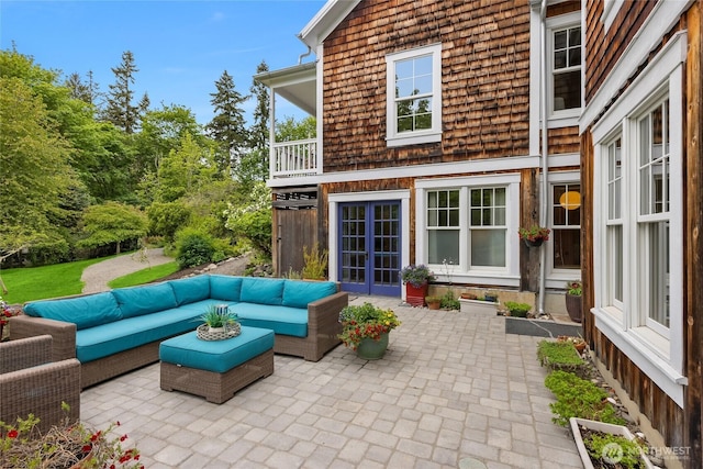 8285 NE Beck Rd, Bainbridge Island, WA 98110 - view of patio / terrace with an outdoor living space, a balcony, and french doors