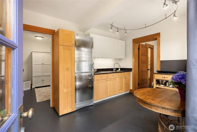 8285 NE Beck Rd, Bainbridge Island, WA 98110 - kitchen with freestanding refrigerator, a sink, dark countertops, and light brown cabinets