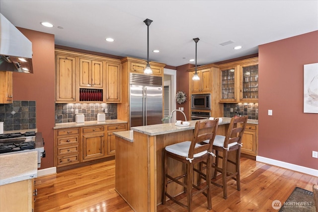 12916 318th Ave NE, Duvall, WA 98019 - kitchen featuring built in appliances, range hood, light wood-style flooring, decorative backsplash, and recessed lighting