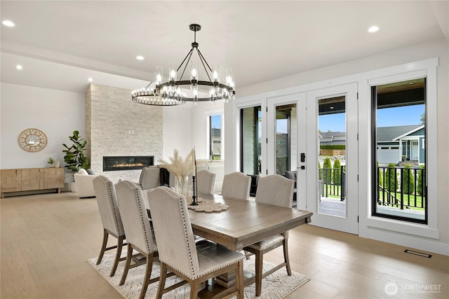 1750 Farmview Ter, Lynden, WA 98264 - dining space with a chandelier, light wood finished floors, a stone fireplace, and recessed lighting