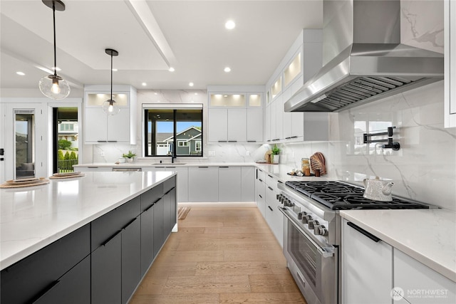 1750 Farmview Ter, Lynden, WA 98264 - kitchen featuring wall chimney range hood, high end stainless steel range, white cabinetry, decorative backsplash, and pendant lighting