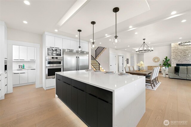 1750 Farmview Ter, Lynden, WA 98264 - kitchen with modern cabinets, appliances with stainless steel finishes, recessed lighting, light wood-type flooring, and white cabinetry