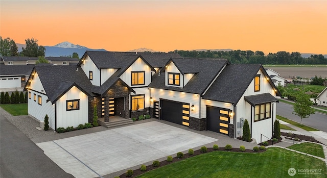 1750 Farmview Ter, Lynden, WA 98264 - view of front of house featuring stone siding, driveway, a lawn, a shingled roof, and board and batten siding