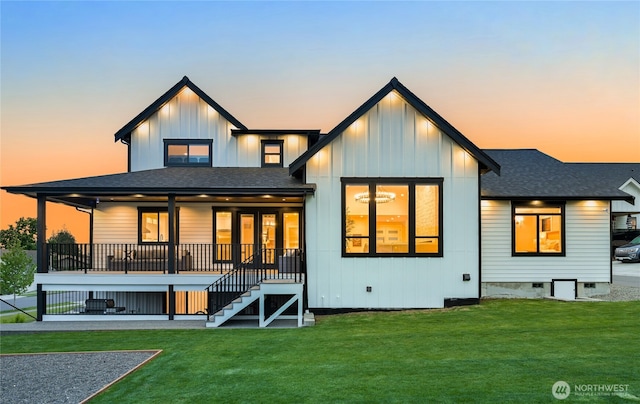 1750 Farmview Ter, Lynden, WA 98264 - back of property at dusk with roof with shingles, a lawn, stairway, and board and batten siding
