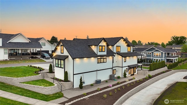 1750 Farmview Ter, Lynden, WA 98264 - view of front of home featuring a residential view, a yard, a shingled roof, and central air condition unit