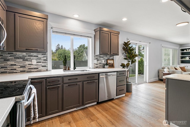 14908 93rd Ave E, Puyallup, WA 98375 - kitchen with stainless steel dishwasher, electric range oven, a sink, light wood finished floors, and recessed lighting