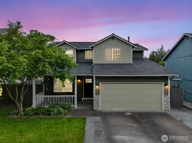 14908 93rd Ave E, Puyallup, WA 98375 - view of front facade with driveway, covered porch, stone siding, a garage, and fence