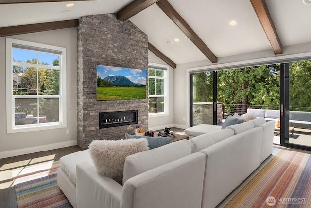 living room with a stone fireplace, baseboards, recessed lighting, and wood finished floors