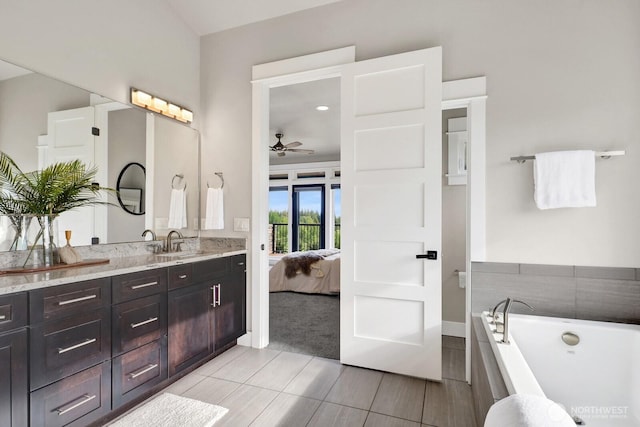 5754 W 26th Crst, Ferndale, WA 98248 - full bathroom with connected bathroom, a ceiling fan, vanity, a bathtub, and baseboards