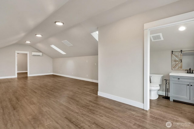 5754 W 26th Crst, Ferndale, WA 98248 - bonus room featuring a wall unit AC, lofted ceiling, wood finished floors, baseboards, and recessed lighting