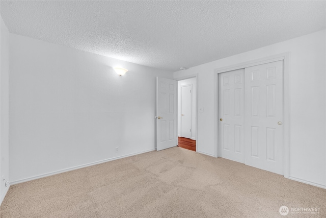 20302 52nd Ave W, Lynnwood, WA 98036 - unfurnished bedroom with a textured ceiling, carpet floors, a closet, and baseboards