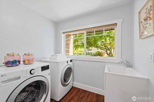 laundry area featuring separate washer and dryer, dark wood-style flooring, and baseboards