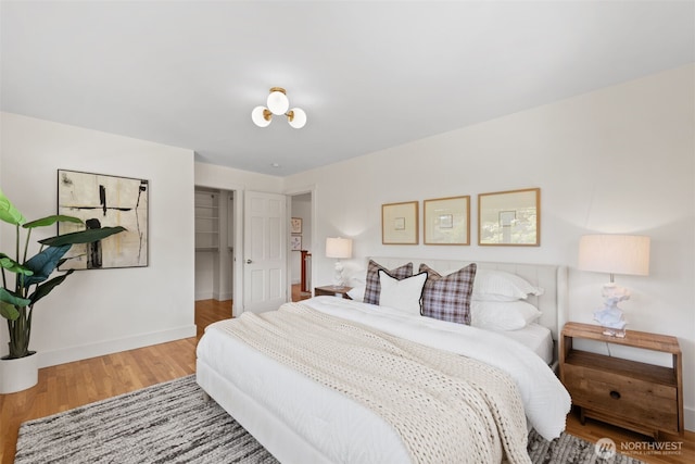 bedroom with wood finished floors and baseboards