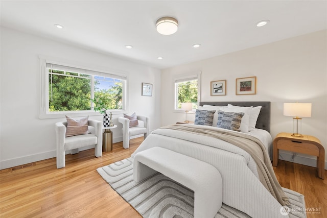bedroom featuring light wood finished floors, baseboards, and recessed lighting