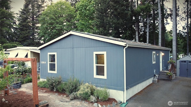 12814 NE 190th Pl, Bothell, WA 98011 - view of side of home with a storage unit and an outdoor structure