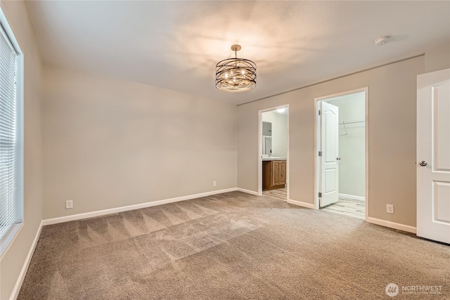 12814 NE 190th Pl, Bothell, WA 98011 - unfurnished bedroom with carpet flooring, a chandelier, a spacious closet, and baseboards