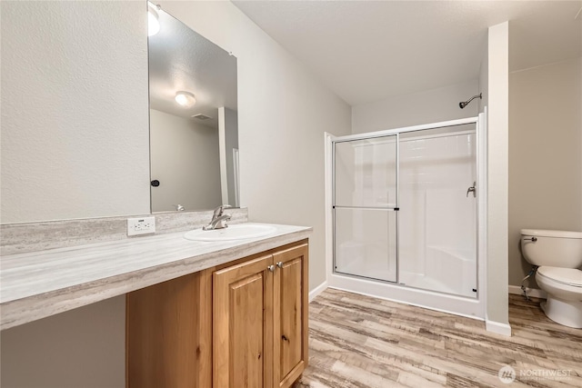 12814 NE 190th Pl, Bothell, WA 98011 - full bathroom with wood finished floors, toilet, a stall shower, and vanity