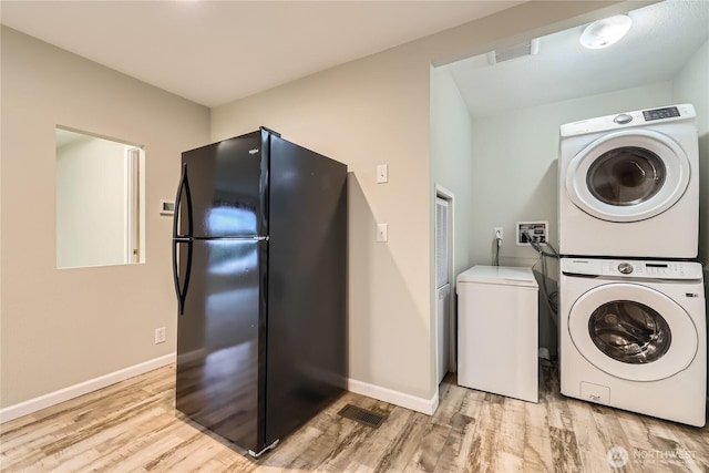 12814 NE 190th Pl, Bothell, WA 98011 - clothes washing area featuring estacked washer and dryer, light wood-style flooring, and baseboards