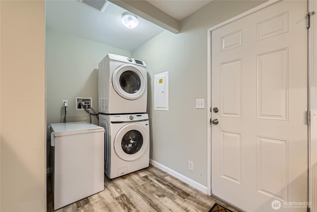 12814 NE 190th Pl, Bothell, WA 98011 - laundry room with stacked washer and clothes dryer, light wood finished floors, and baseboards