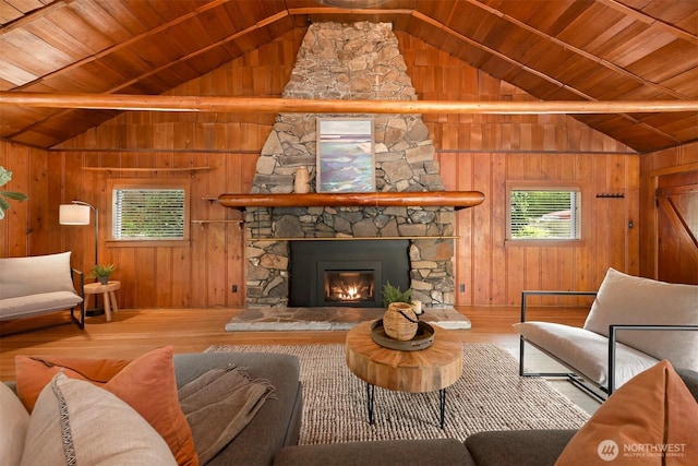 1414 Roy Rd, Bellingham, WA 98229 - living room featuring wooden ceiling, wood finished floors, a stone fireplace, and wood walls