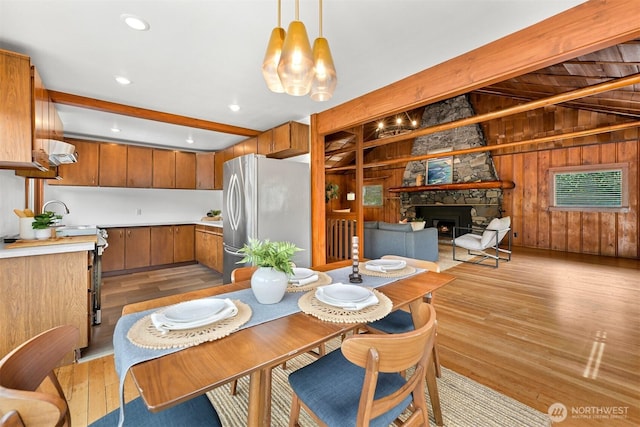 1414 Roy Rd, Bellingham, WA 98229 - dining space featuring light wood finished floors, wood walls, a fireplace, and recessed lighting