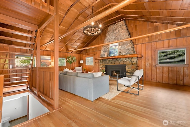 1414 Roy Rd, Bellingham, WA 98229 - living room featuring wooden ceiling, wood finished floors, vaulted ceiling, a fireplace, and wooden walls