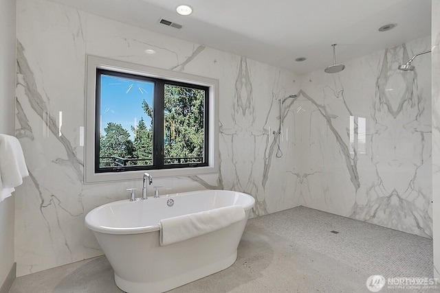 6950 SE Maker St, Mercer Island, WA 98040 - full bath featuring stone wall, a marble finish shower, a soaking tub, and tile walls
