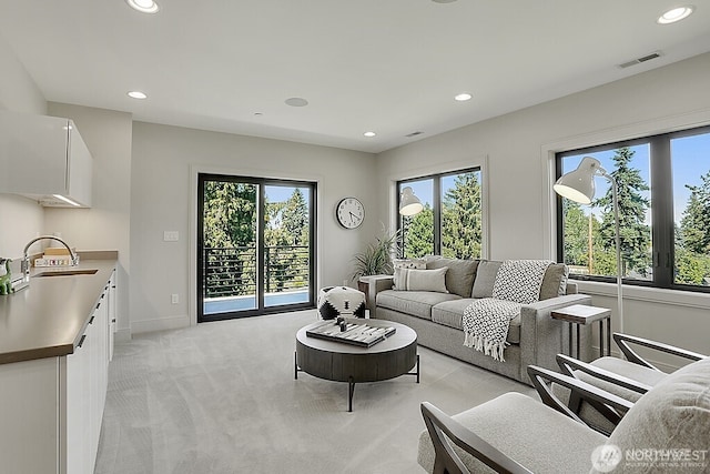 6950 SE Maker St, Mercer Island, WA 98040 - living room with plenty of natural light, recessed lighting, light colored carpet, and baseboards