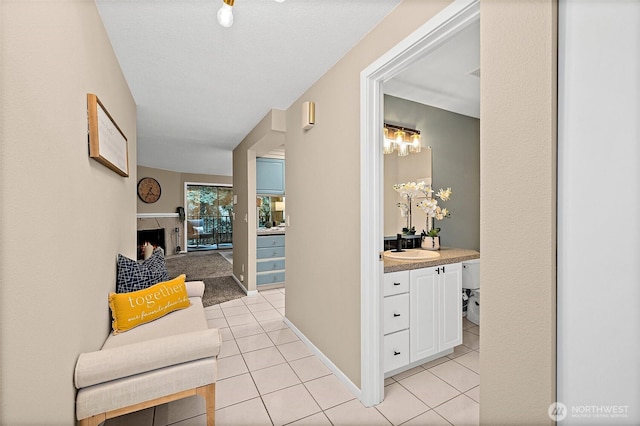 15314 4th Ave SW Unit 3, Burien, WA 98166 - hallway featuring light tile patterned floors, a sink, and baseboards